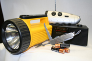 Image of a flashlight and batteries as emergency preparedness items for your kit.