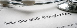 Close-up of a stethoscope resting on a document titled “Medicaid Eligibility.”