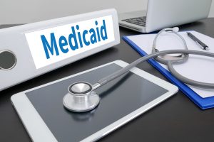 Medicaid folder on Desktop on table. ipad