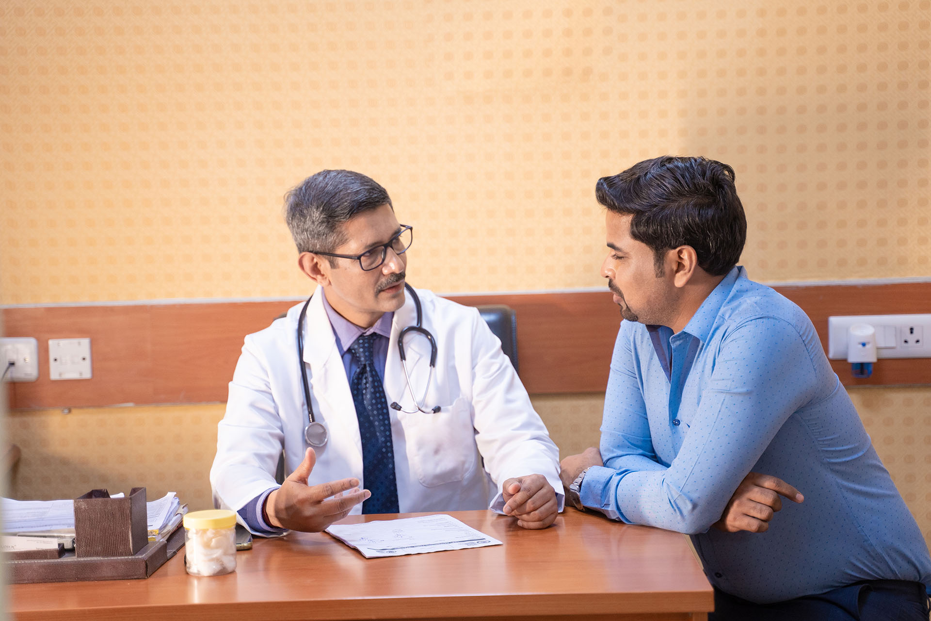 doctor talking with patient at clinic