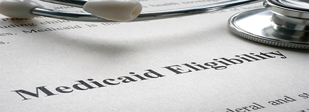 Close-up of a stethoscope resting on a document titled “Medicaid Eligibility.”