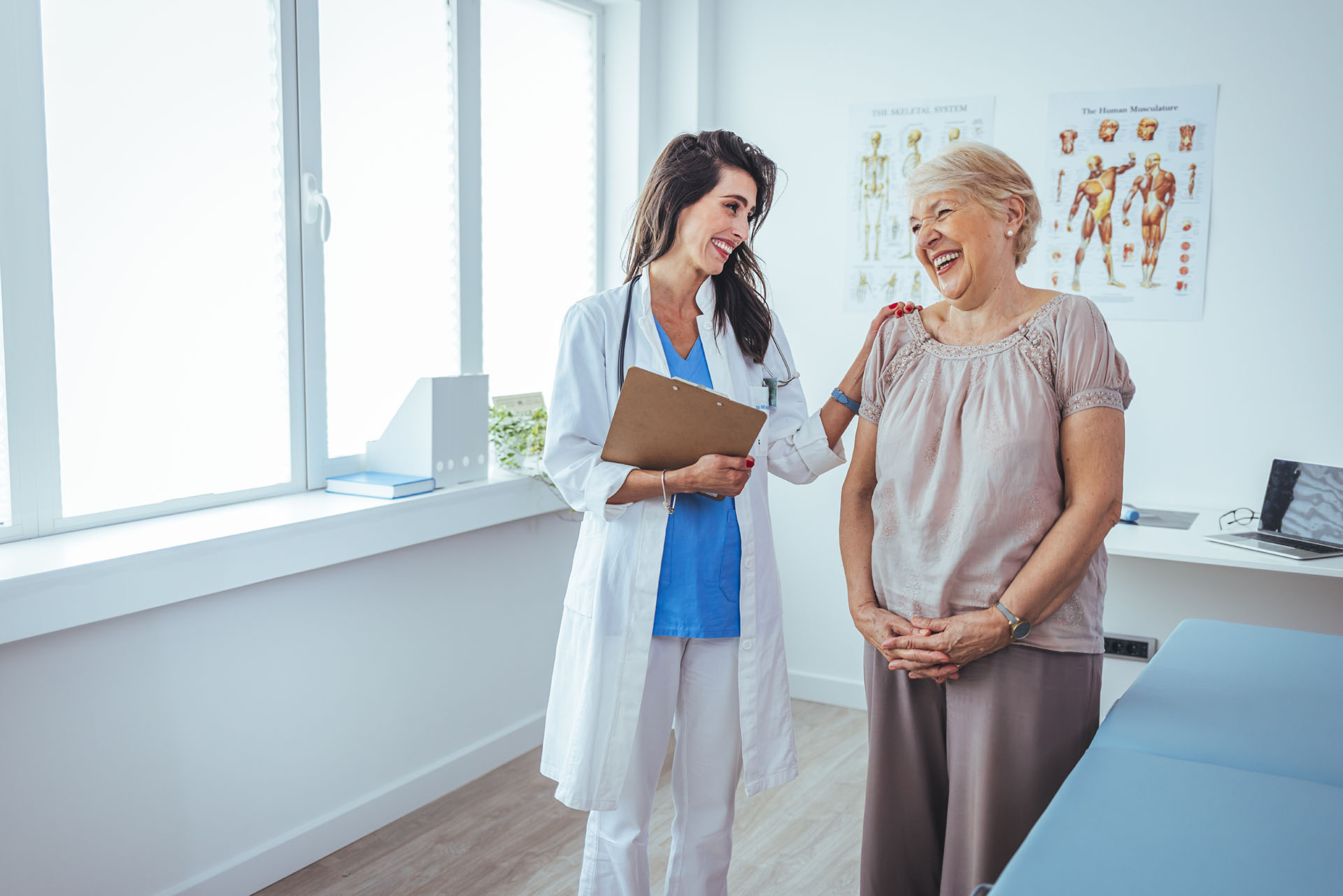 Smiling female patient at consultation with doctor. Patient Having Consultation With Doctor In Office.