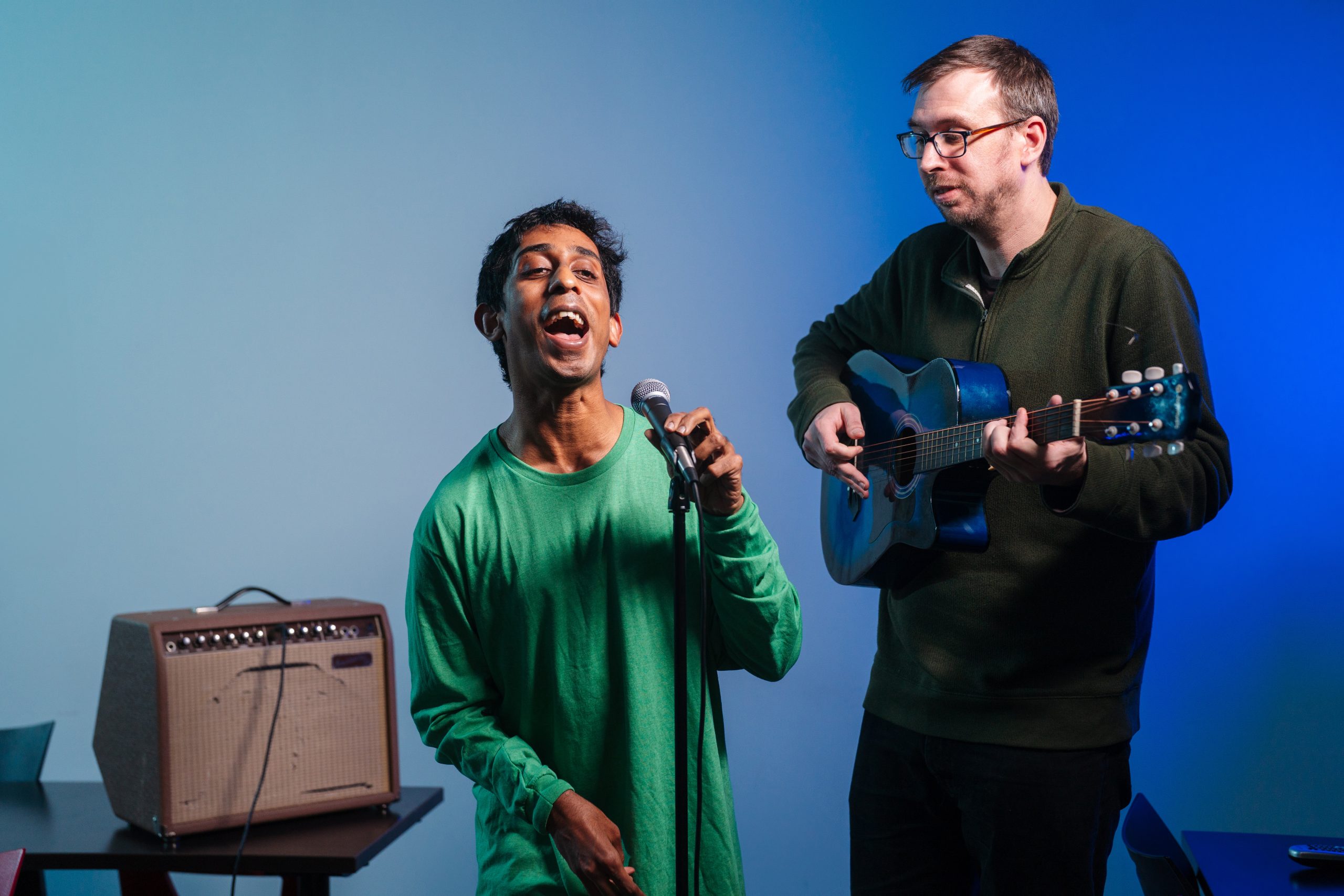 A picture of two individuals playing music