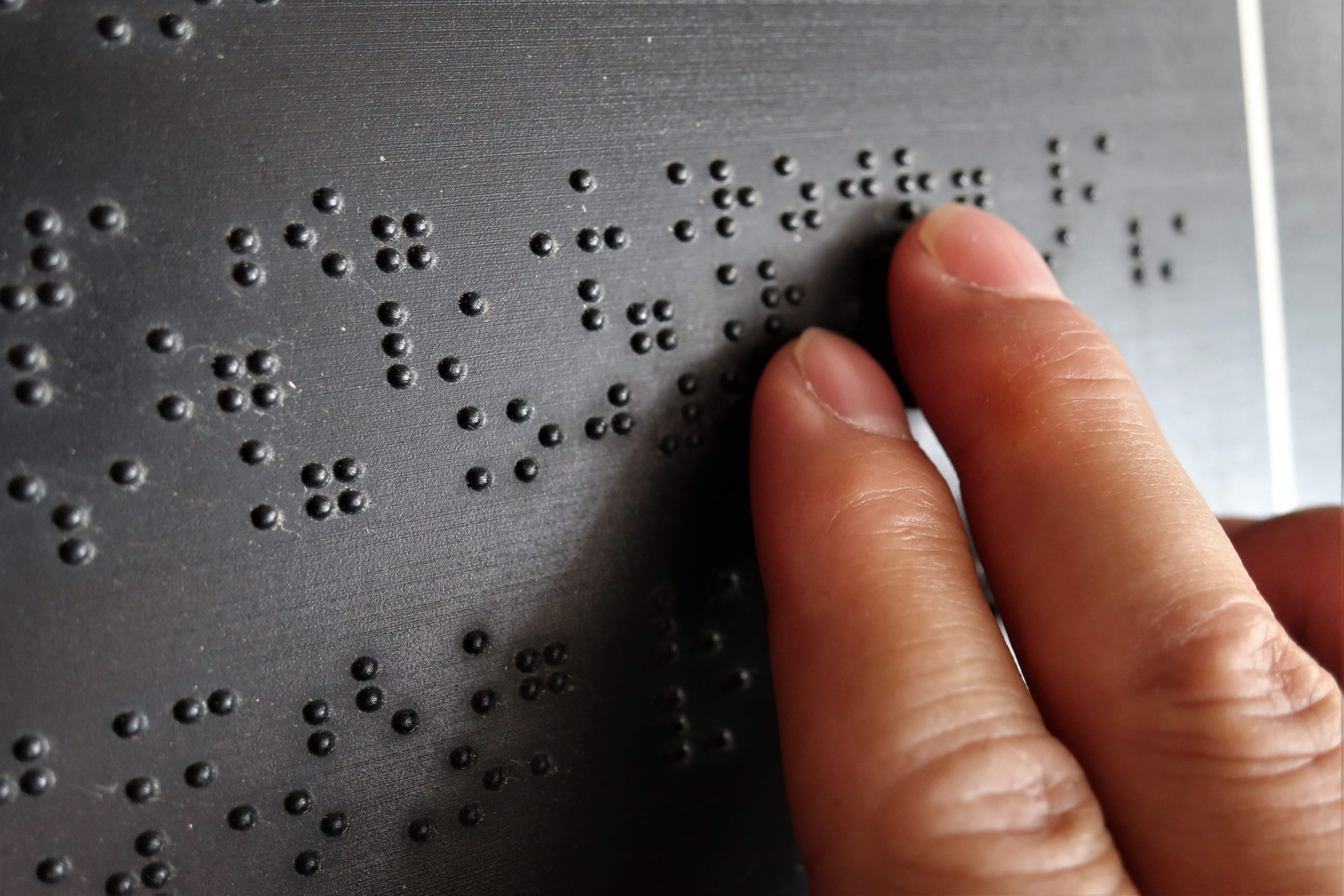 A person reading brail