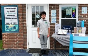 Eddie, owner of Second Exchange standing in front of his store front location