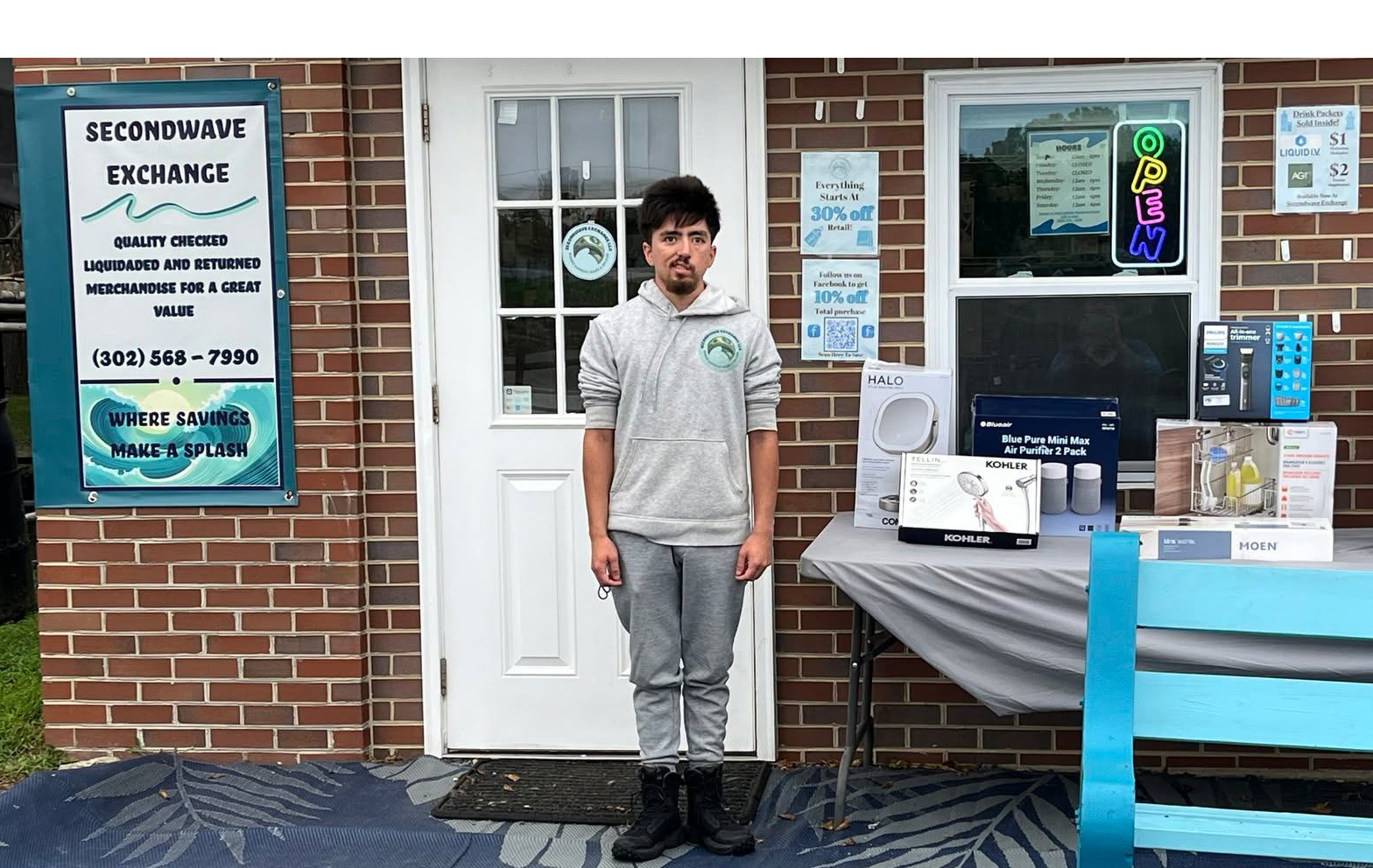 Eddie, owner of Second Exchange standing in front of his store front location